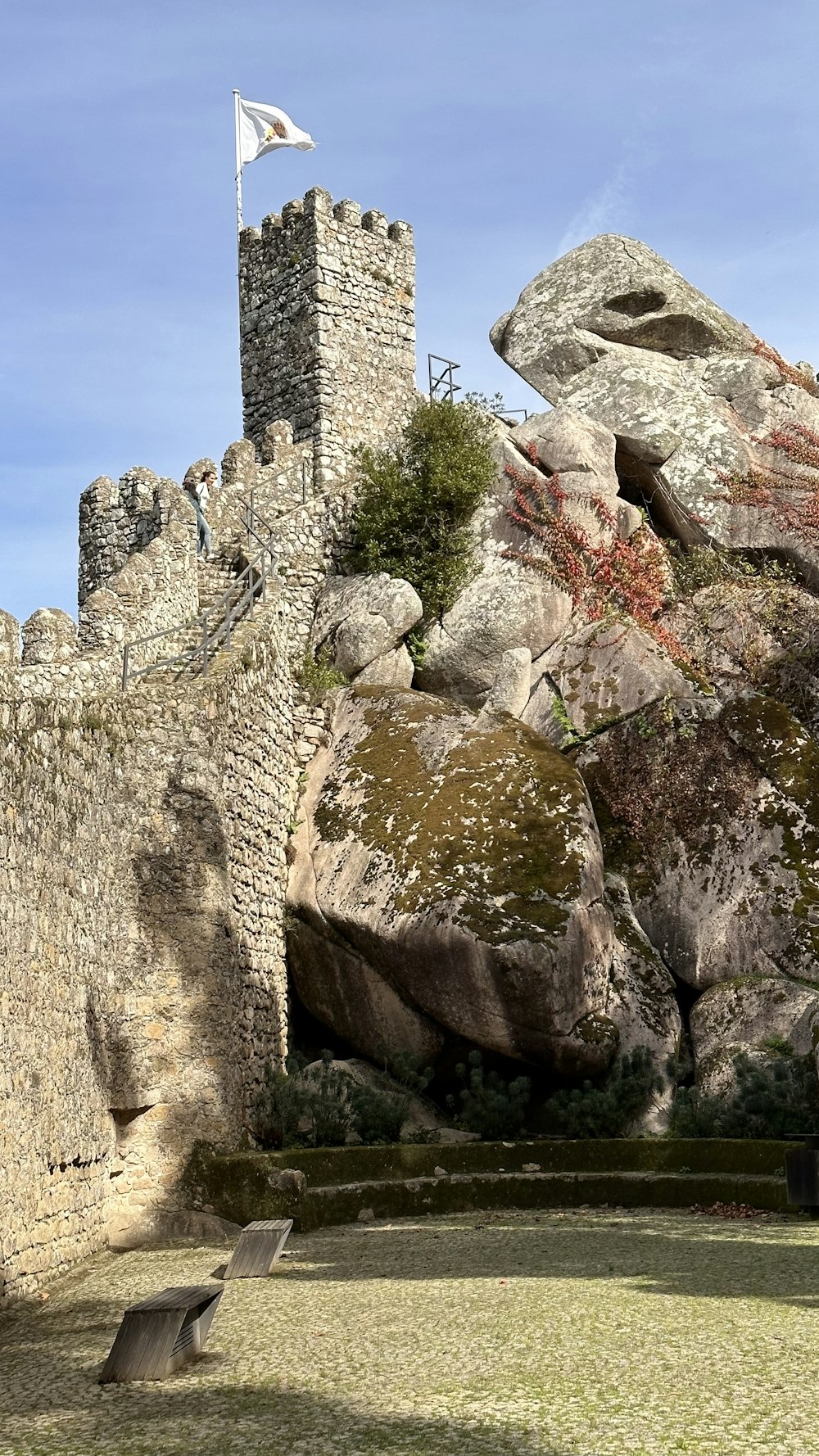 a stone castle with a flag on top of it