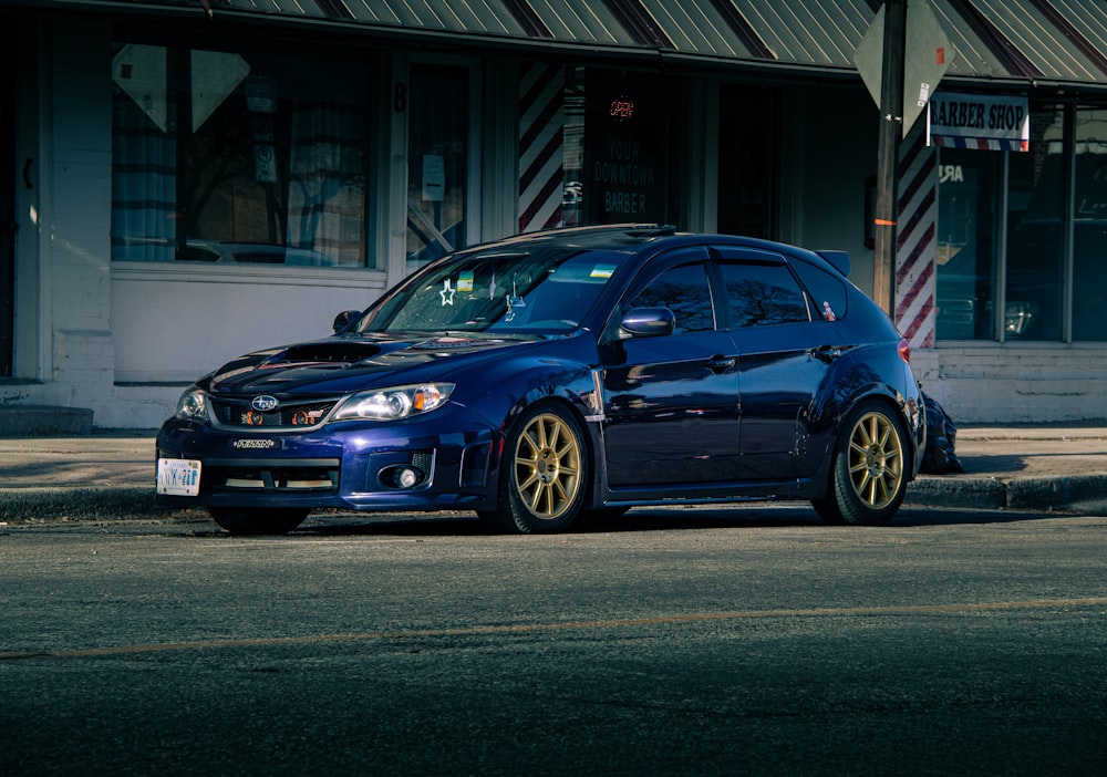 a blue car parked on the side of the road