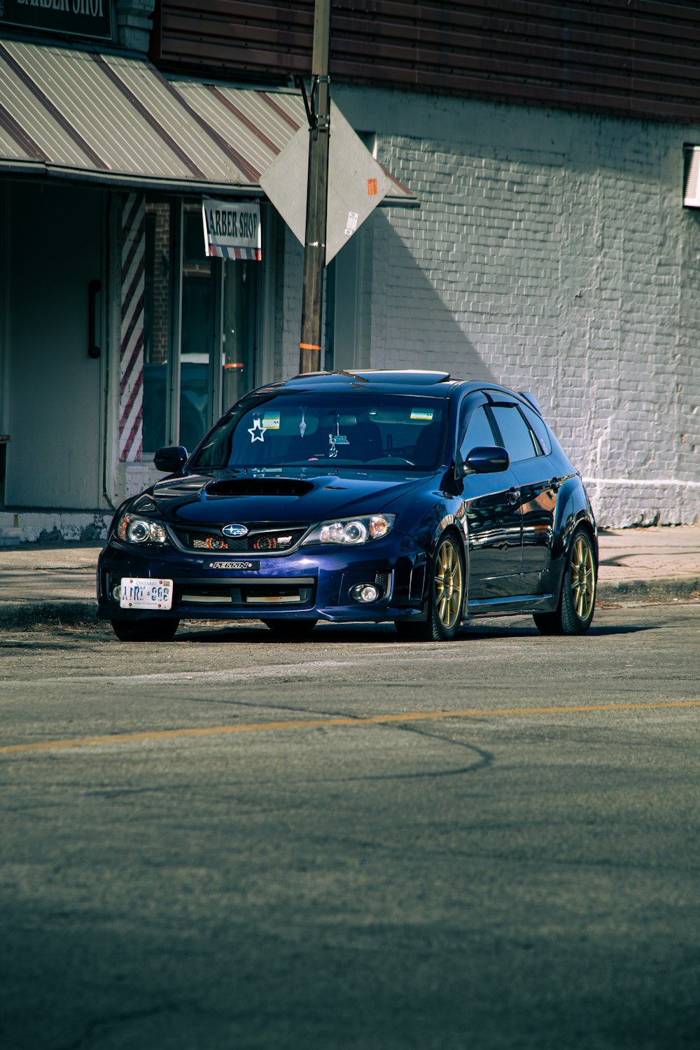 a blue car parked on the side of the road