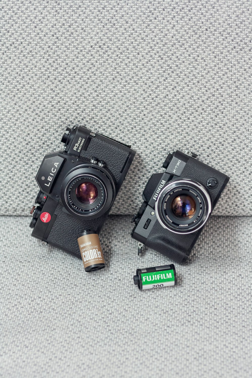 a couple of cameras sitting on top of a table