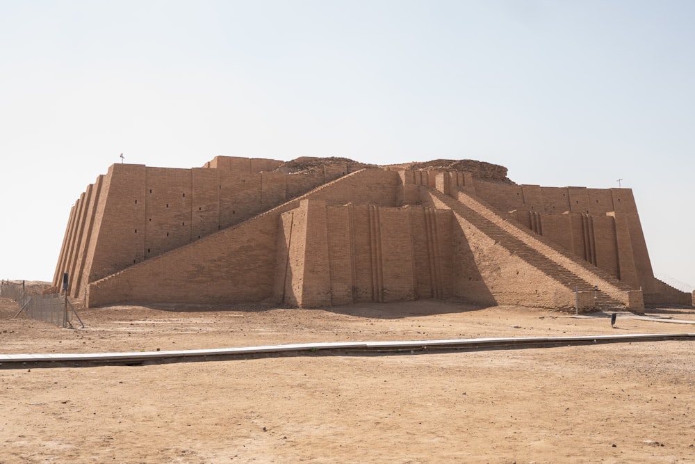 a large stone structure sitting in the middle of a desert