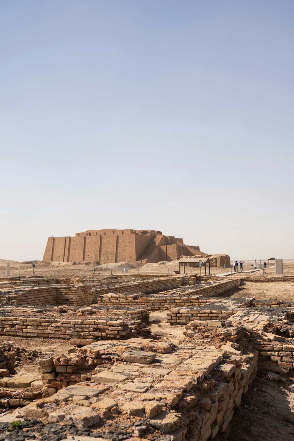 a group of people standing in front of a large structure