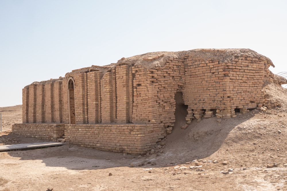 a large brick structure sitting in the middle of a desert