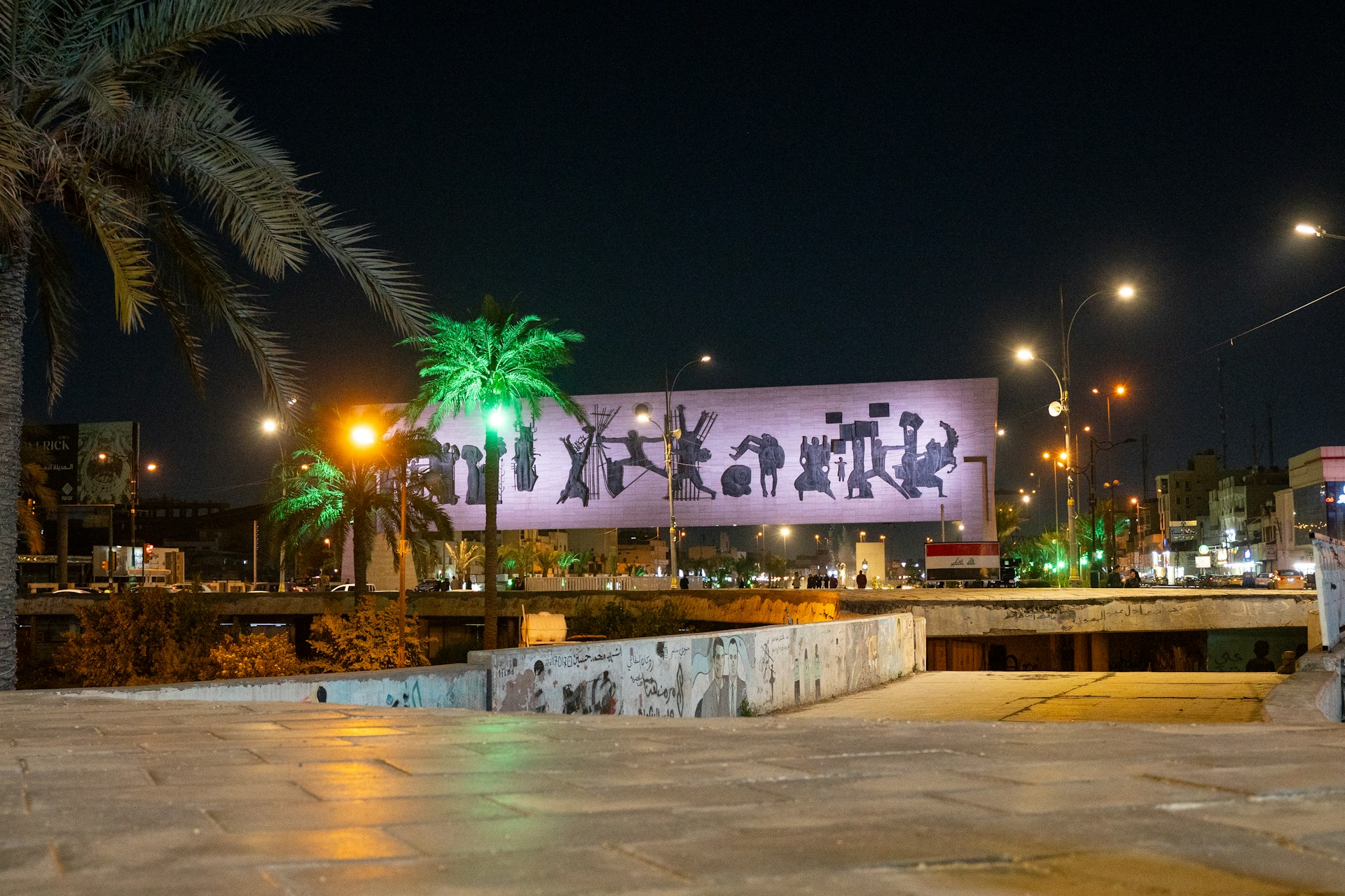 a large billboard is lit up at night
