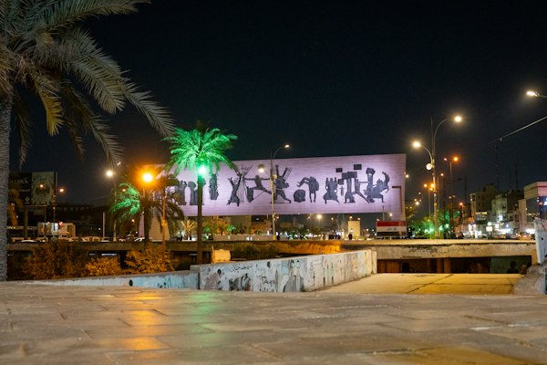 A large billboard is lit up at night — Baghdad, Iraq