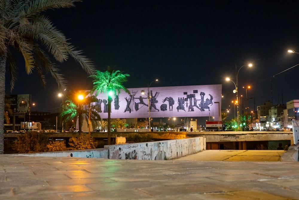 a large billboard is lit up at night