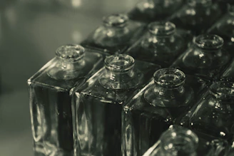 a row of glass bottles sitting on top of a counter