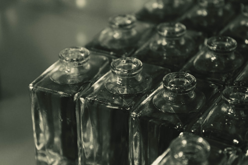 a row of glass bottles sitting on top of a counter