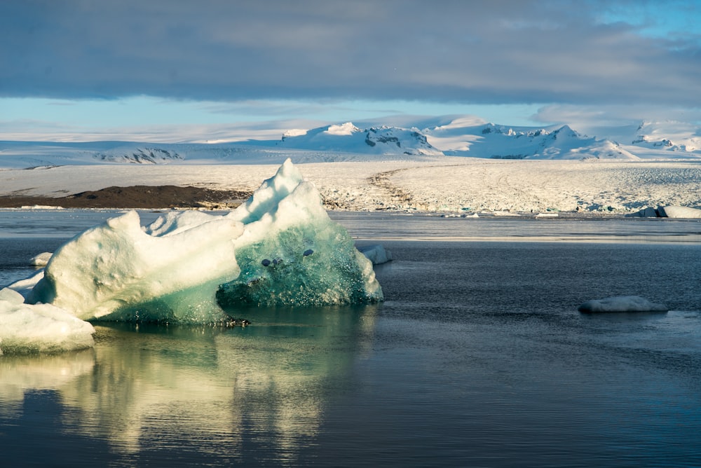 a large iceberg floating on top of a body of water