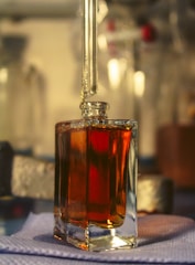 a bottle of liquid sitting on top of a table
