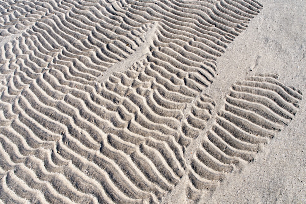 a tire track in the sand on a beach