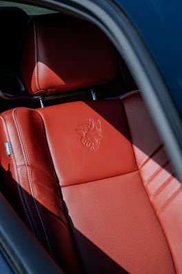 the interior of a car with red leather seats
