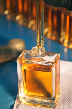 a small square bottle of oil sitting on top of a table