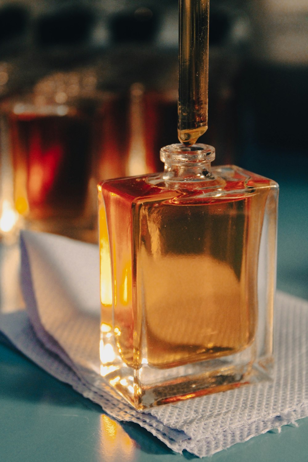 a bottle of perfume sitting on top of a napkin