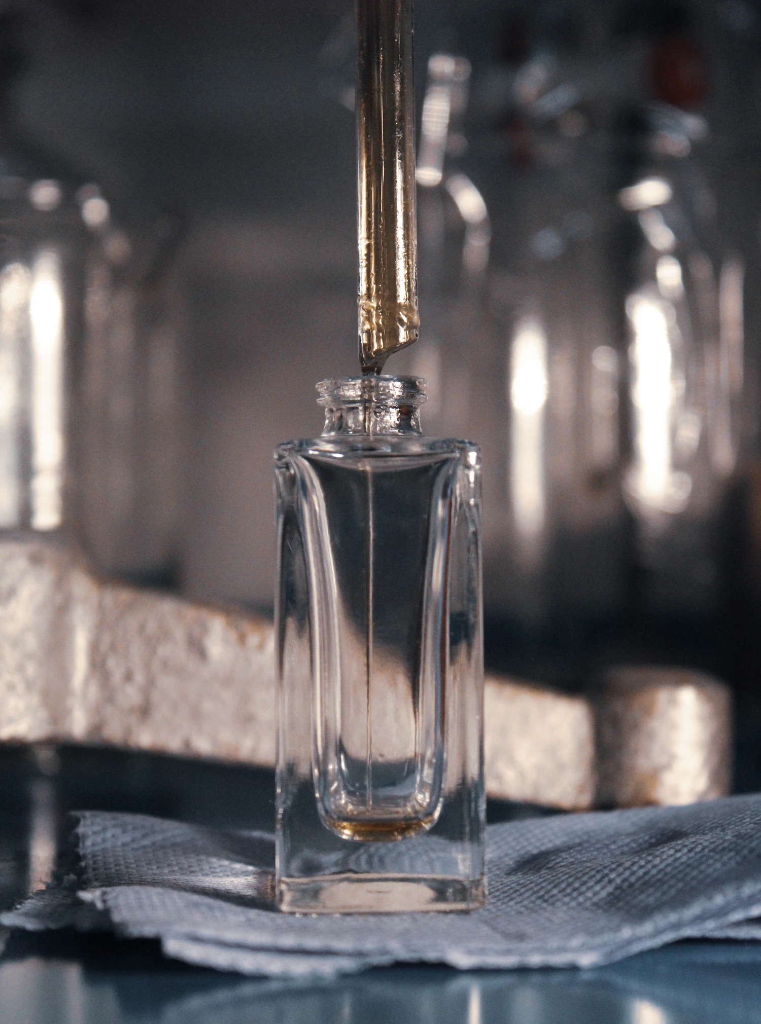 The tall Ventiquattro flacon on a folded cloth as the first drops of concentrate fall from the pipette