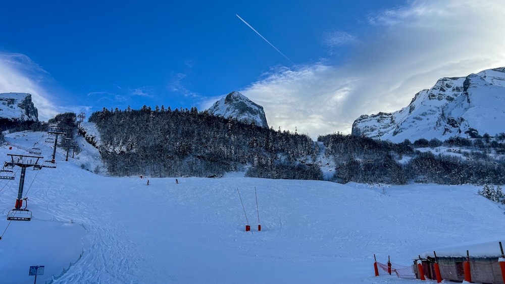 a ski slope with a mountain in the background
