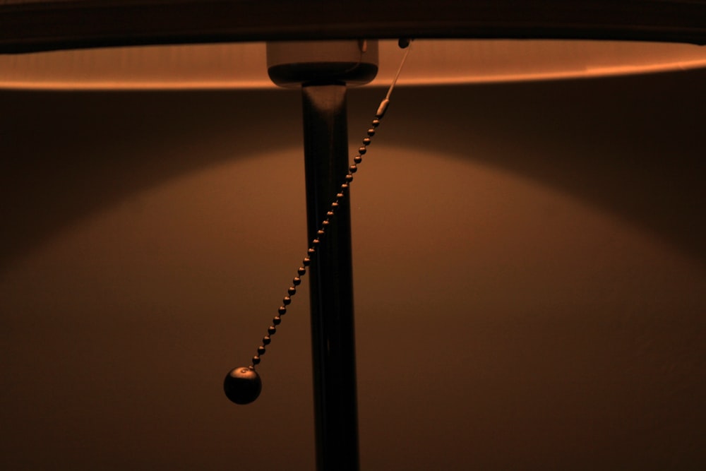 a lamp with a bead chain hanging from it