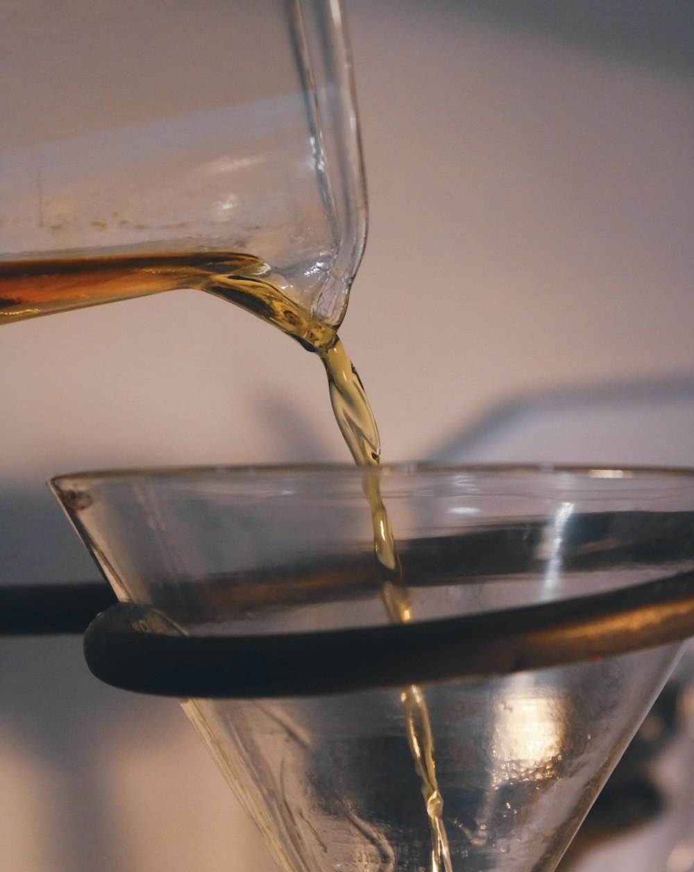 a glass filled with liquid sitting on top of a table