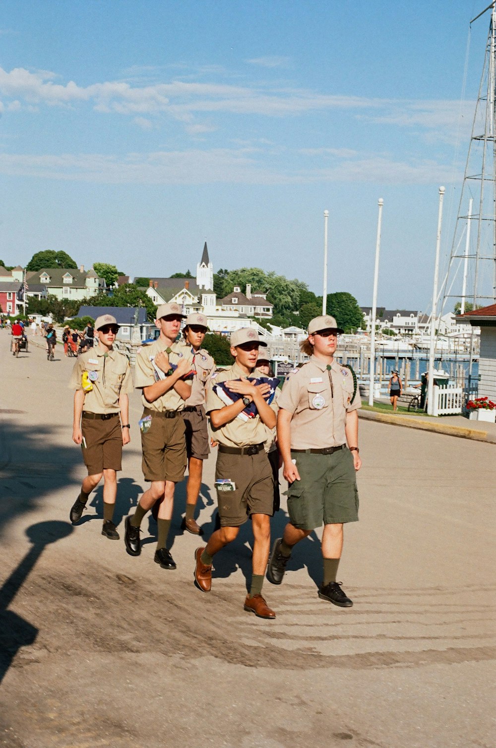 a group of men walking down a street next to each other