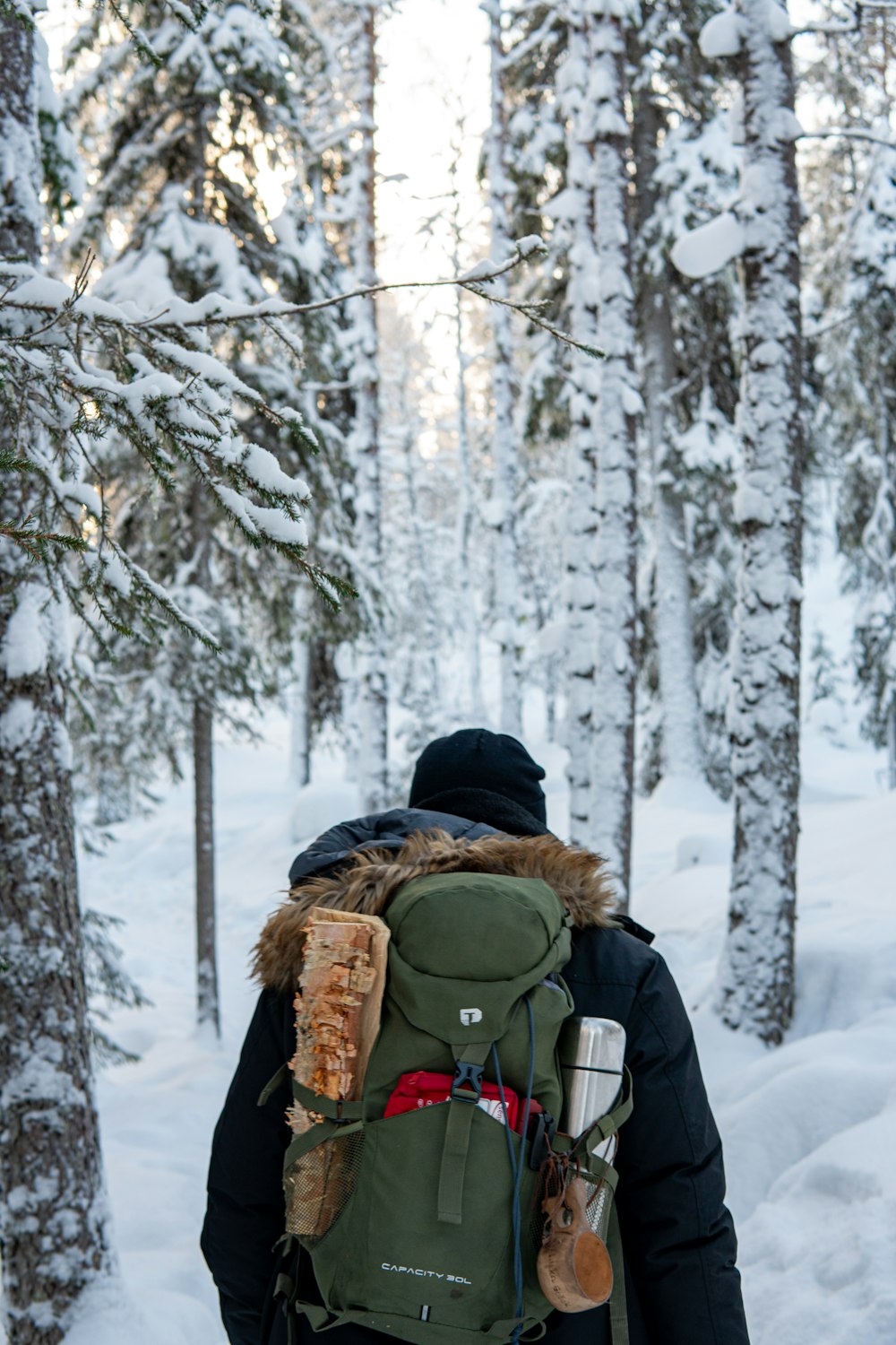 a man with a backpack walking through the woods