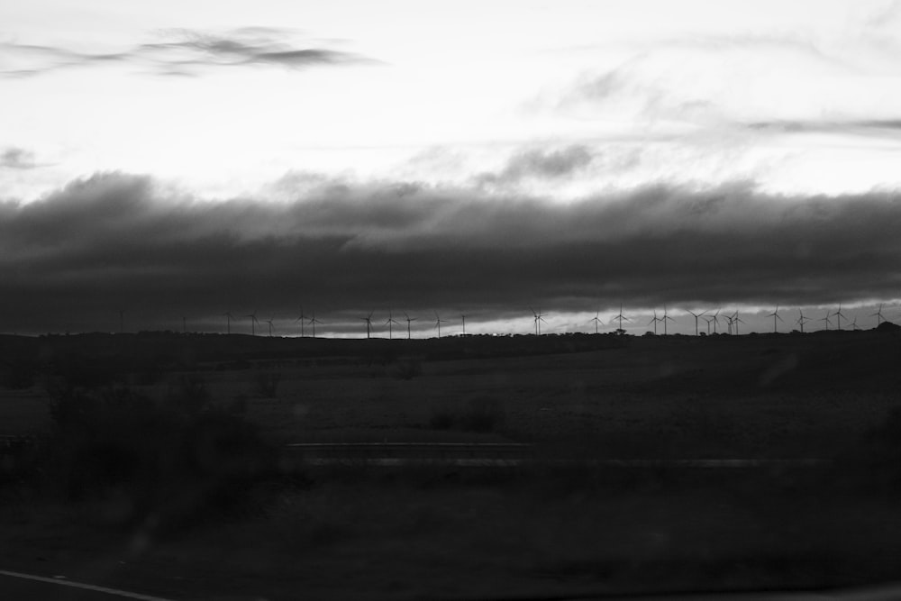 a black and white photo of a wind farm