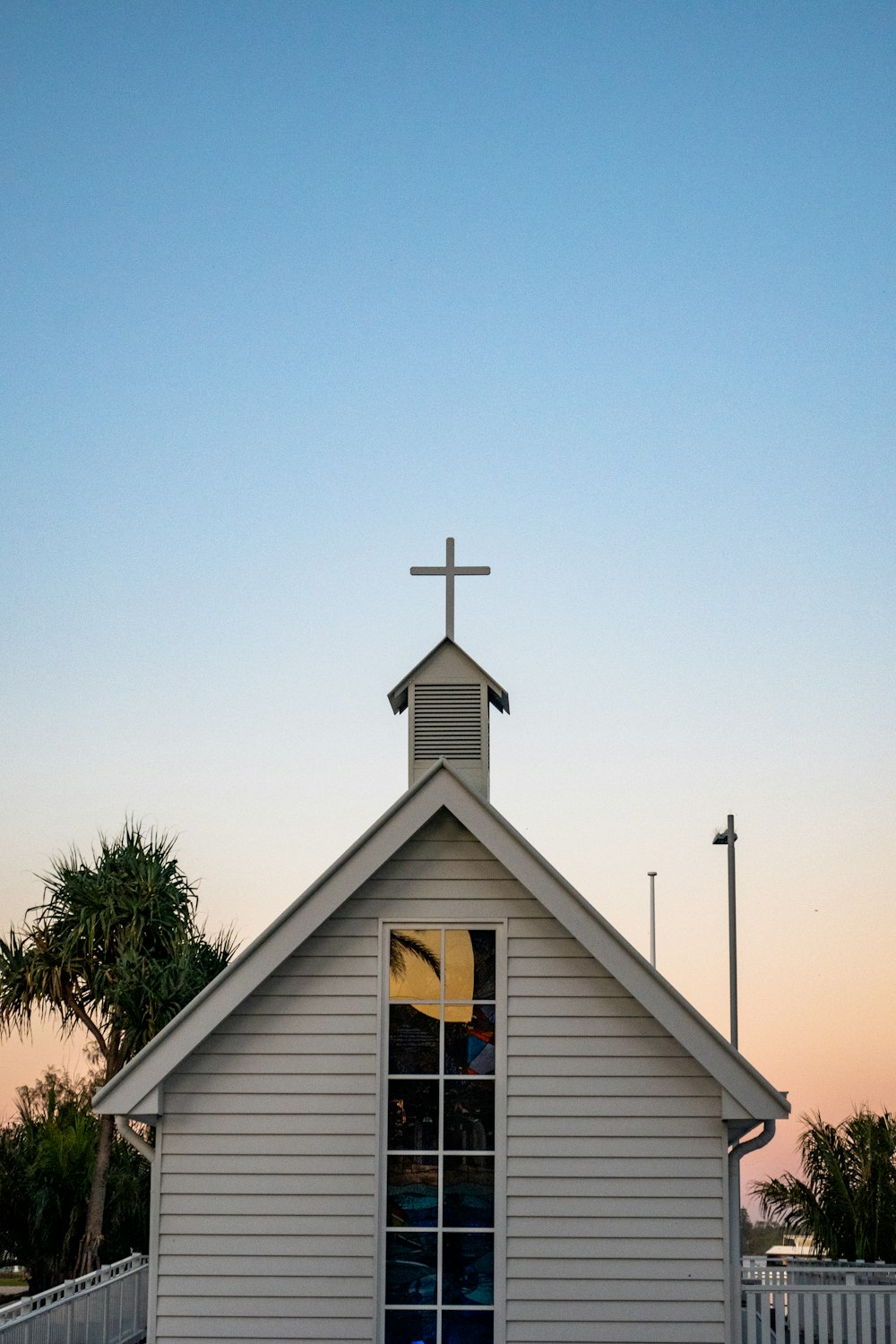 a white church with a cross on top of it