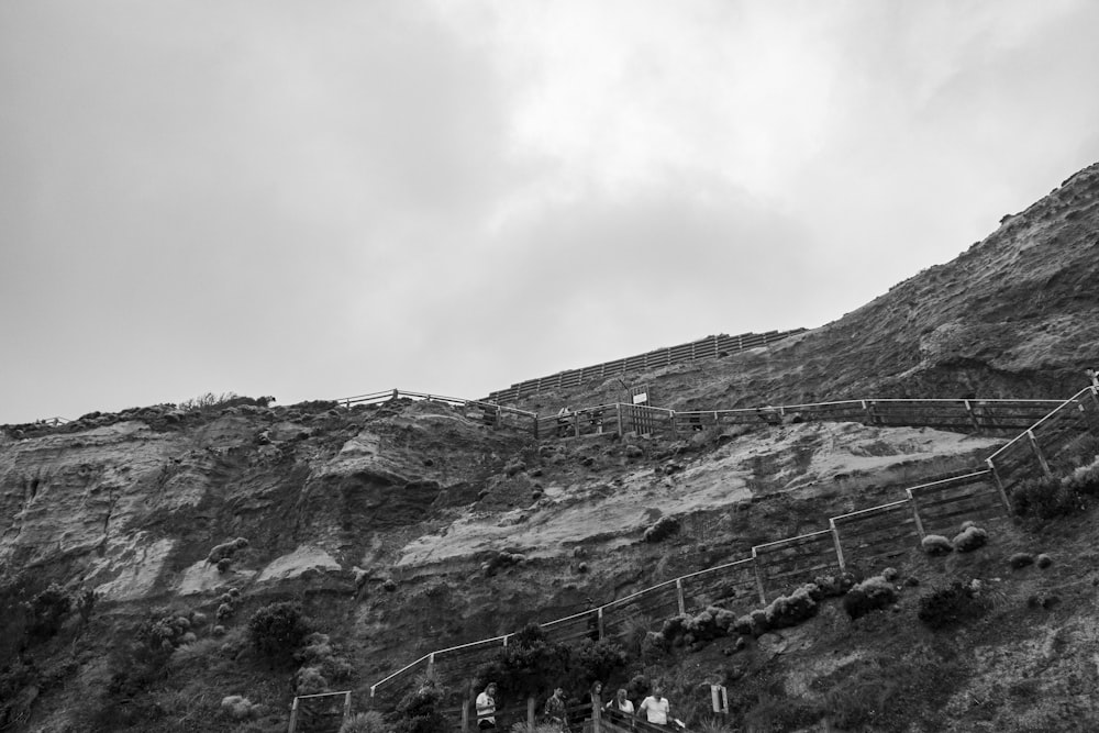 a group of people walking up a steep hill