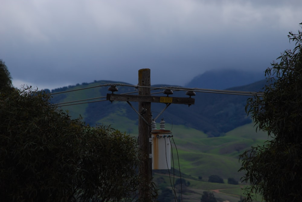 a telephone pole with a sky in the background