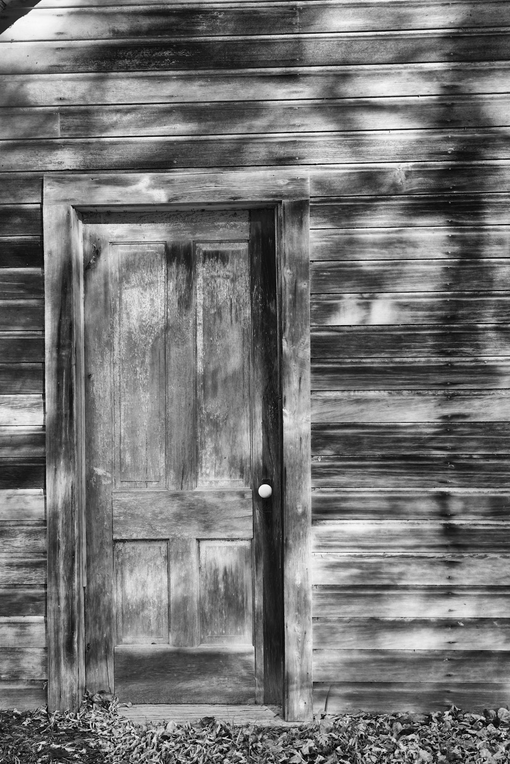 a black and white photo of a wooden door