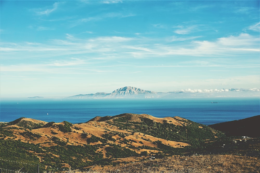 a view of a mountain range with a body of water in the background