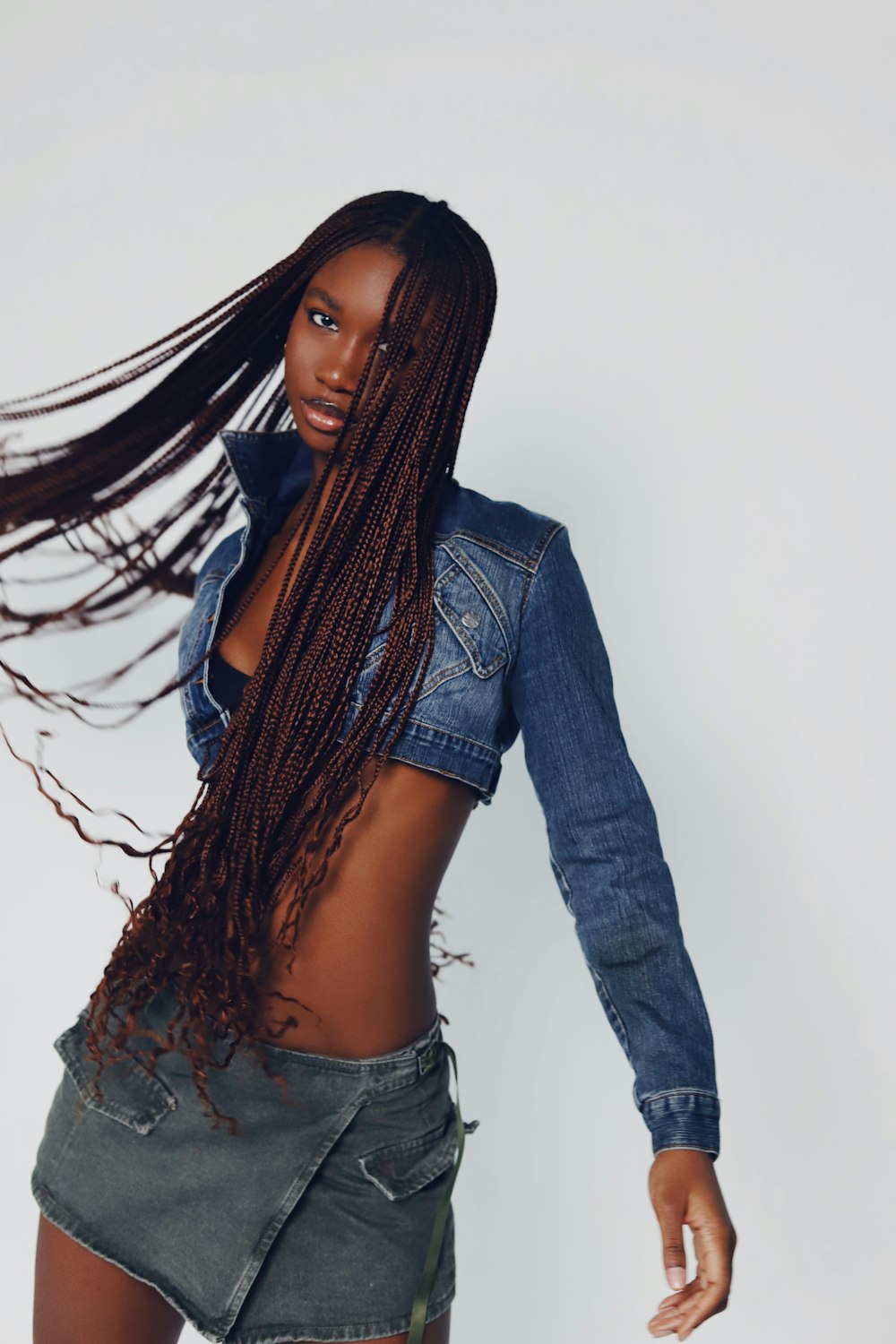 a woman with long hair and a jean jacket