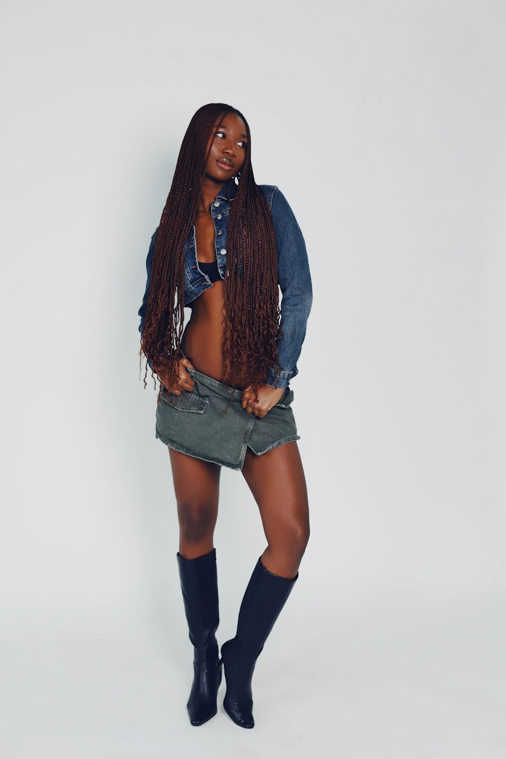 a woman with long hair and boots posing for a picture