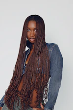 a woman with long hair wearing a jean shirt