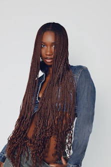 a woman with long hair wearing a jean shirt