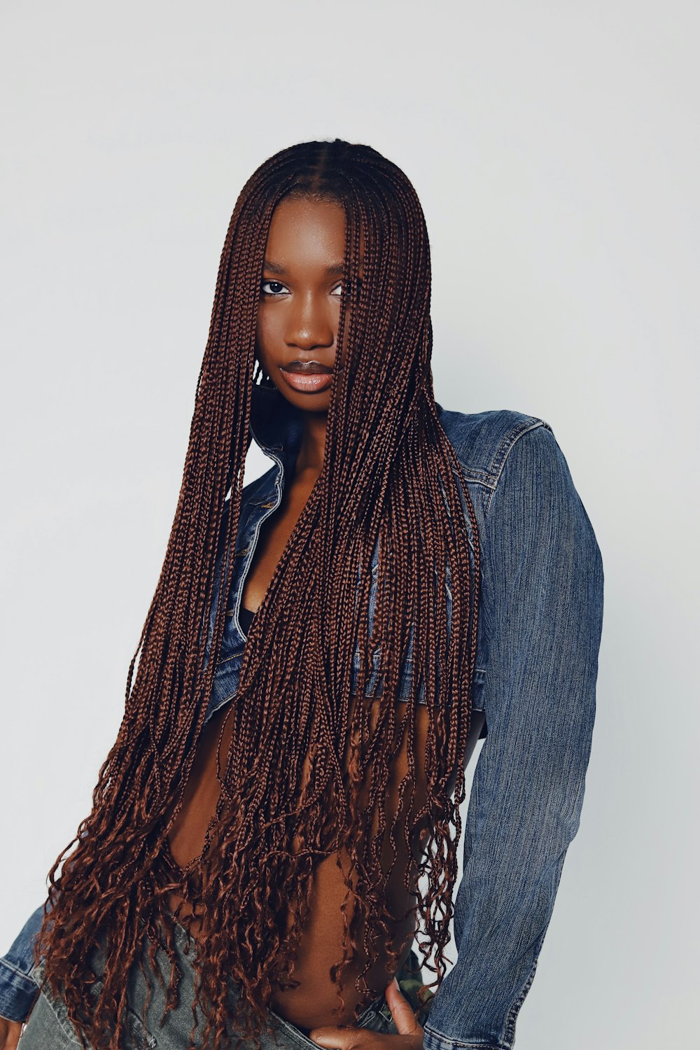 a woman with long hair wearing a jean shirt