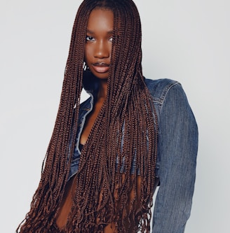 a woman with long hair wearing a jean shirt