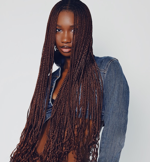 a woman with long hair wearing a jean shirt