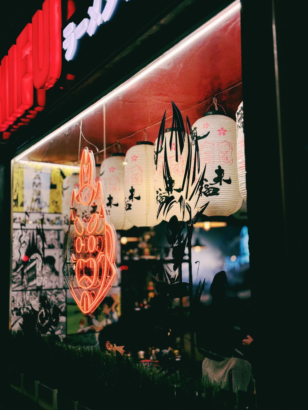 a neon sign is lit up in front of a store