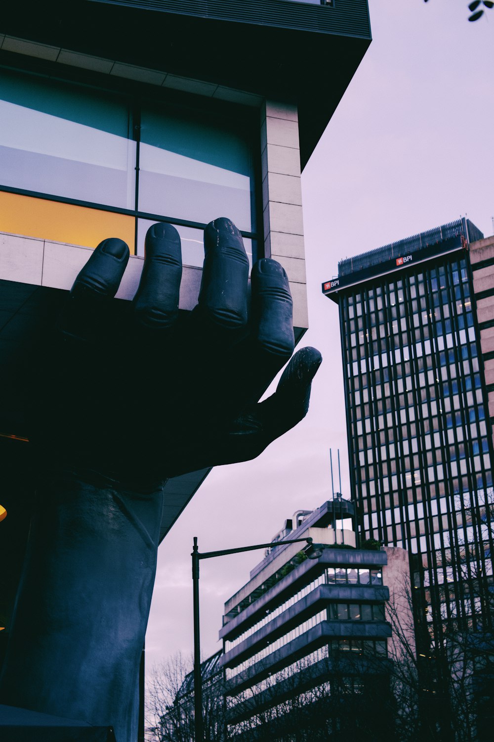 a statue of a hand reaching out of a building