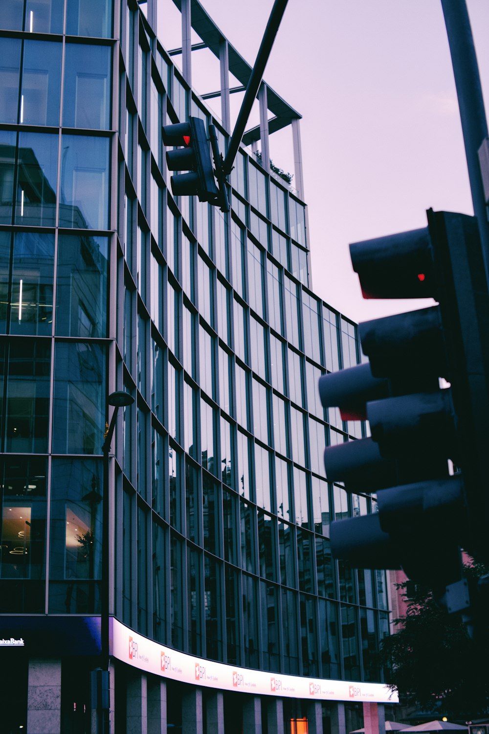 a traffic light in front of a tall building