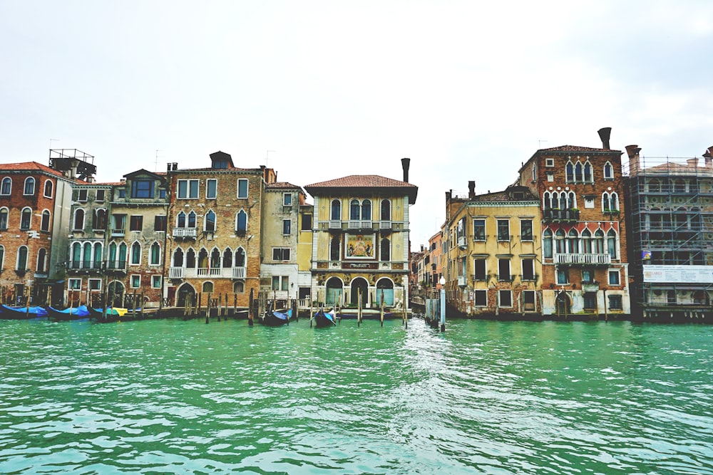 a row of buildings sitting next to a body of water