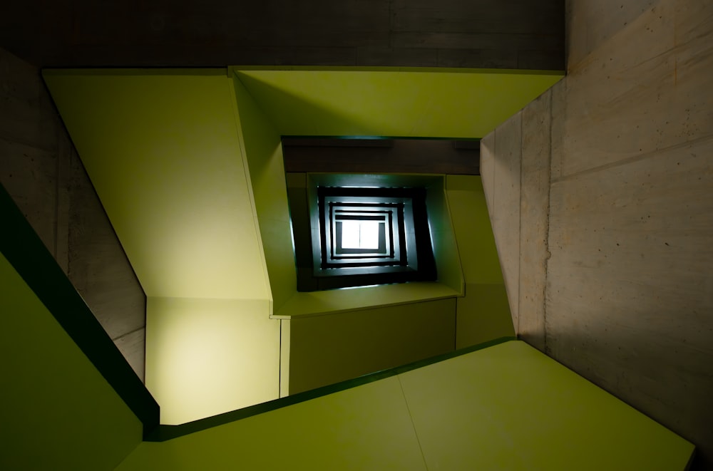 a room with a green wall and a window