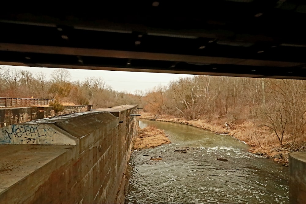 a view of a river from under a bridge