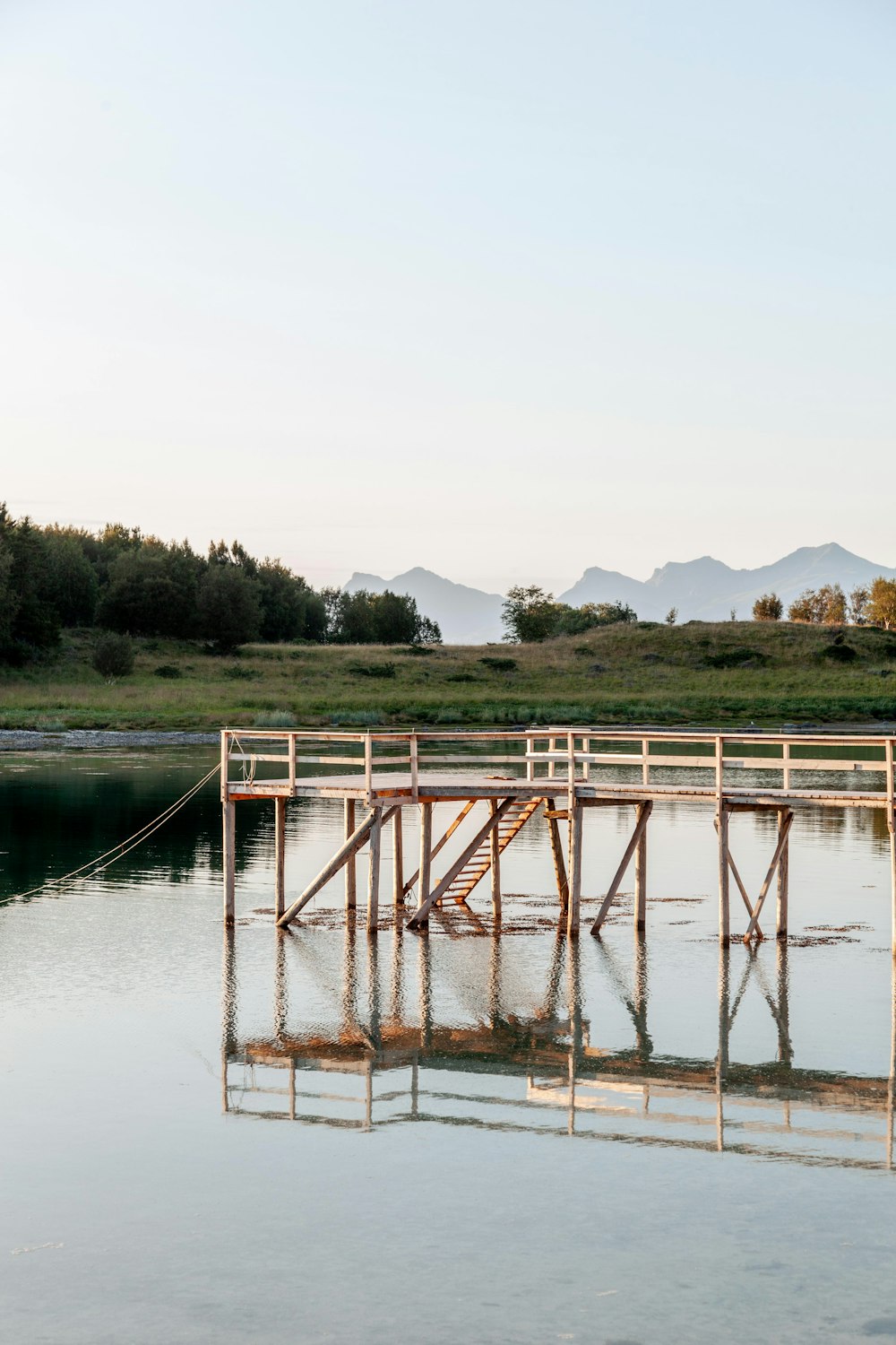 a wooden dock sitting in the middle of a lake