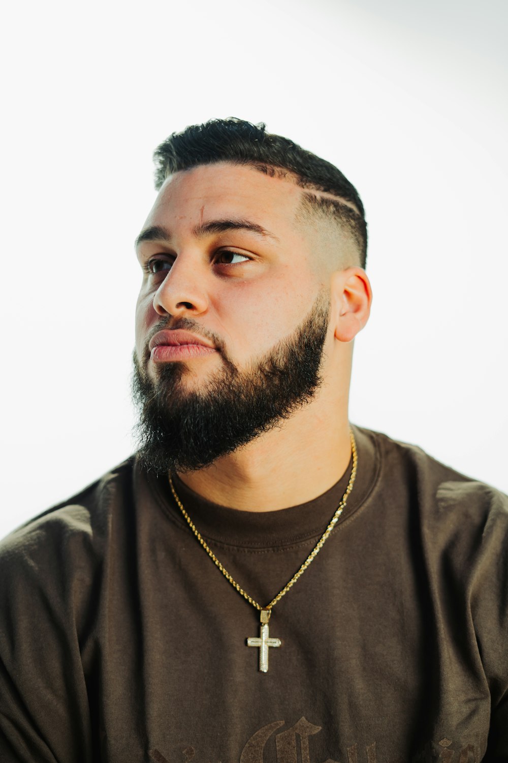 a man with a beard and a cross necklace