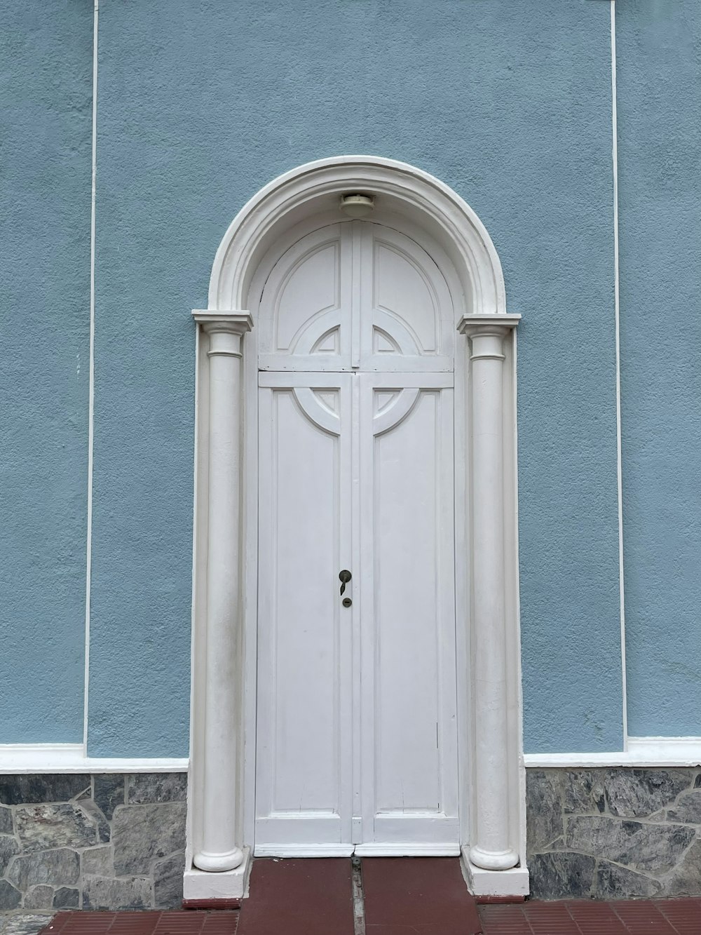 a blue and white building with a white door