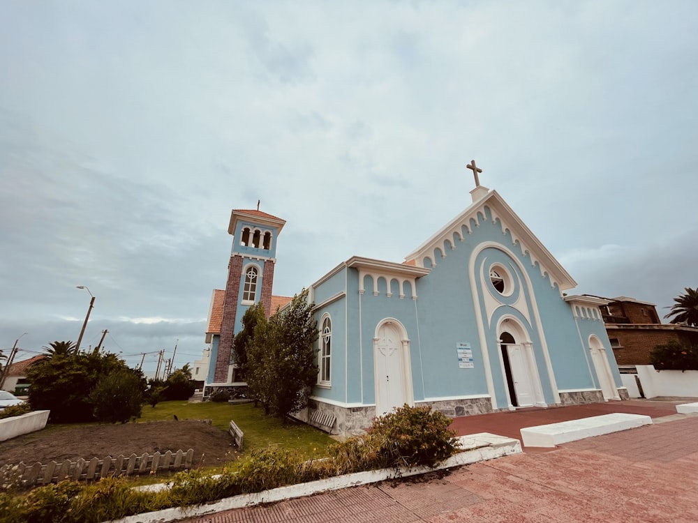 a blue and white church with a clock tower