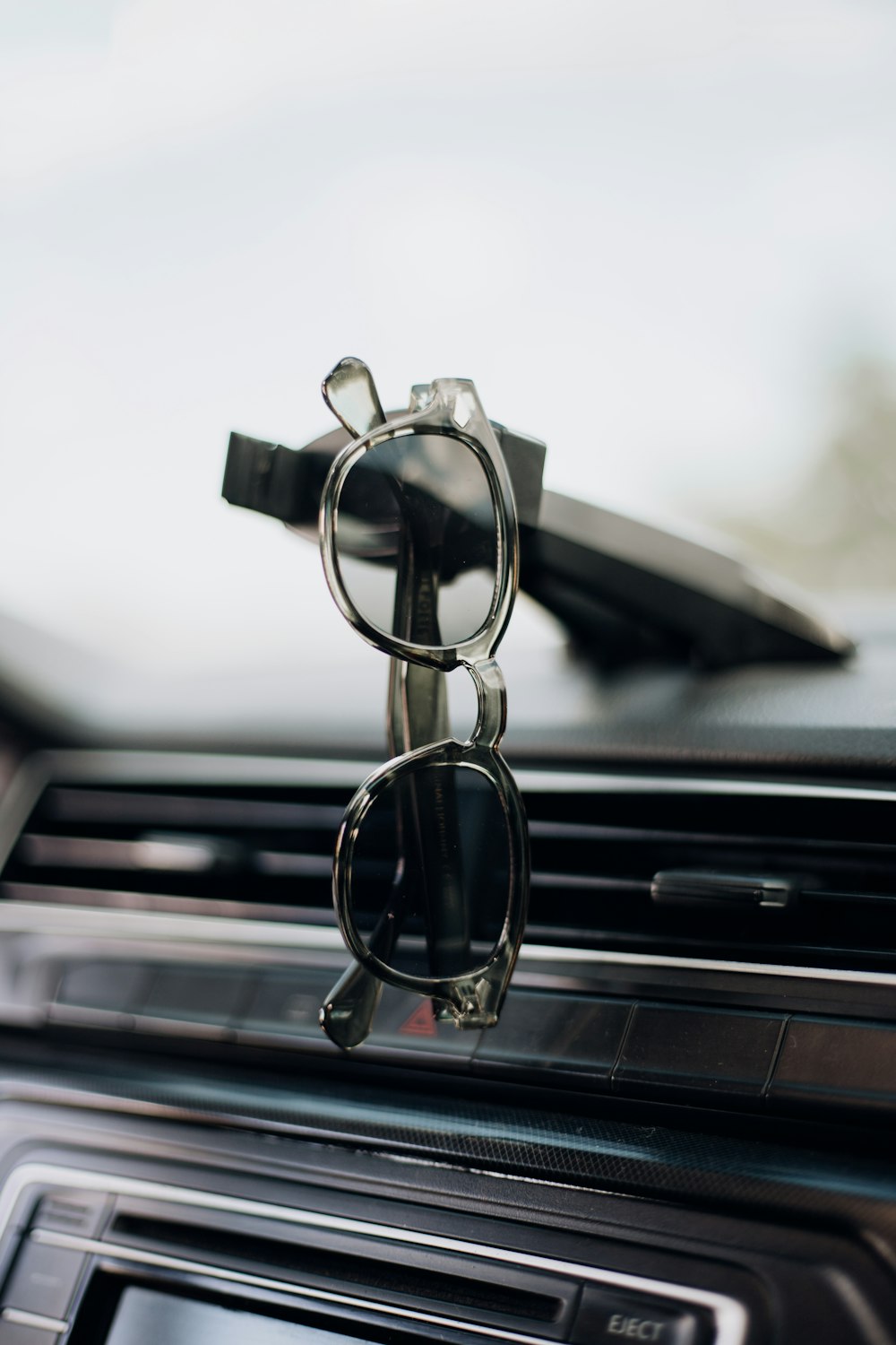 a pair of sunglasses sitting on the dashboard of a car
