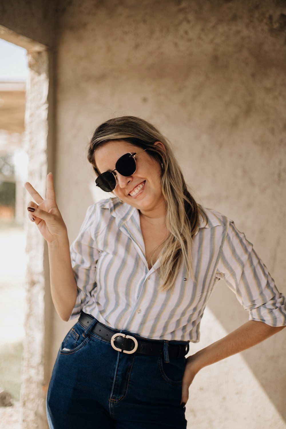 a woman in a striped shirt and black sunglasses