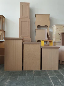 a pile of cardboard boxes sitting on top of a floor